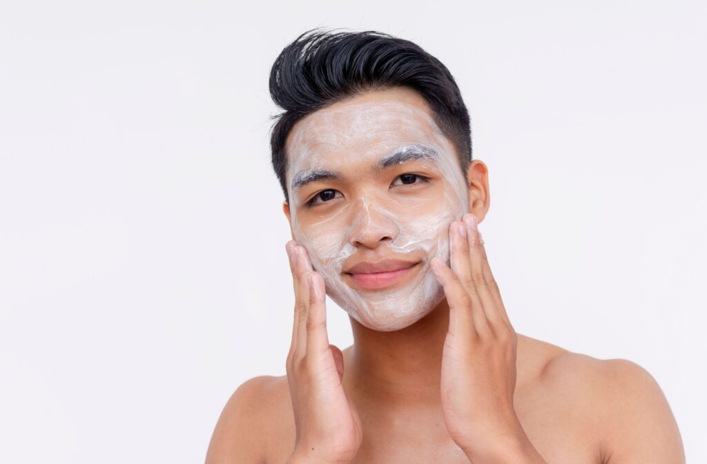 A person uses a gentle cleanser to exfoliate their skin