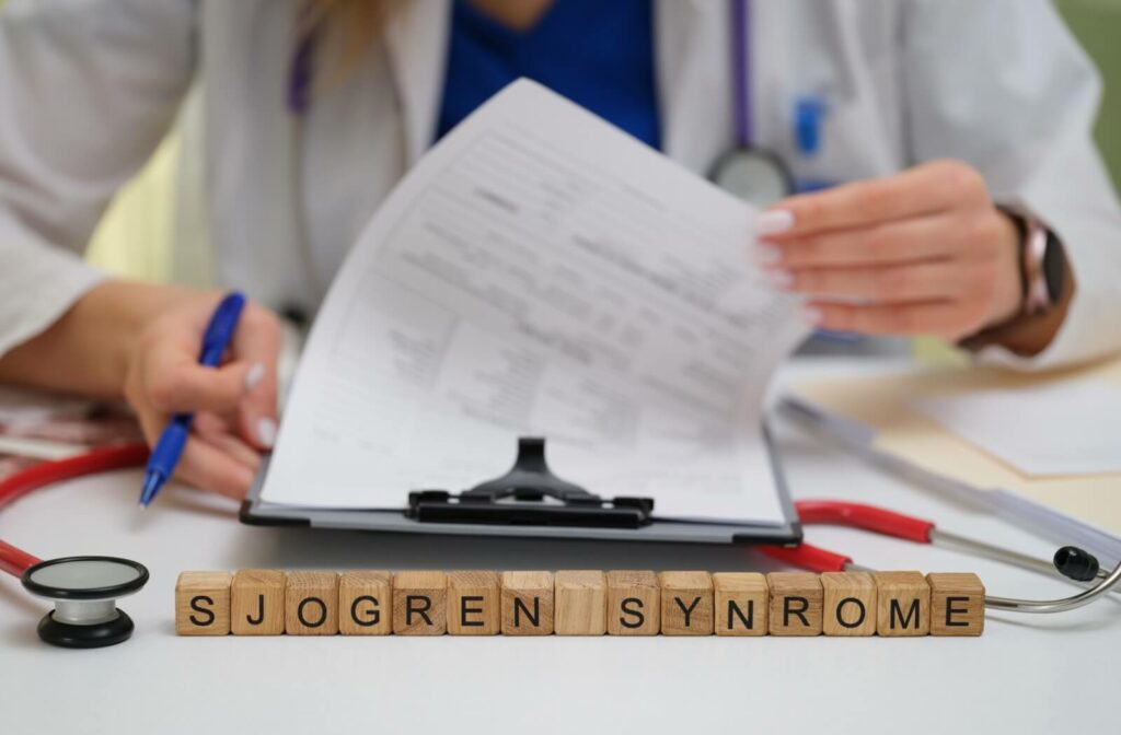 Medical professional reviewing a file with blocks labeled Sjögren's Syndrome.